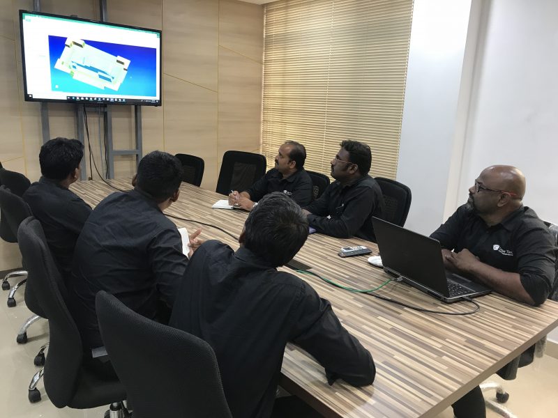 The Cavalier Tool India team sitting around a conference table discussing the kick-off of a new mold design project.