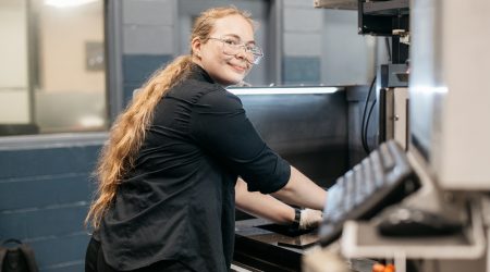 Cynthia Cooper operating an EDM Machine at Cavalier Tool