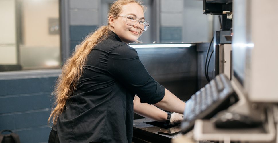 Cynthia Cooper operating an EDM Machine at Cavalier Tool