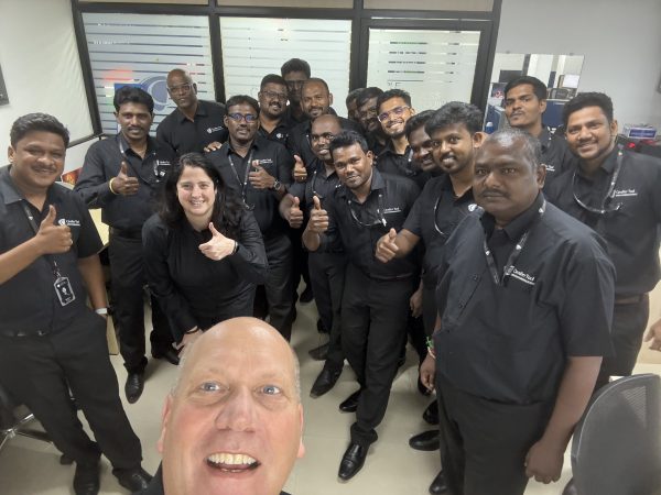 International Business Development Manager Chris Vander Park and CFO Diane Woodiwiss pose for a picture with Cavalier Tool India Staff Members. Diane is giving as thumbs up.